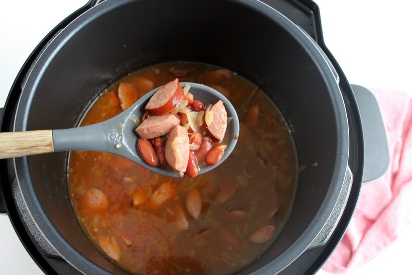 overhead shot of Spoonful of Red Beans and Rice over pressure cooker