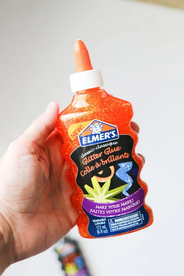 Bottle of Elmer's Glue in Orange glitter