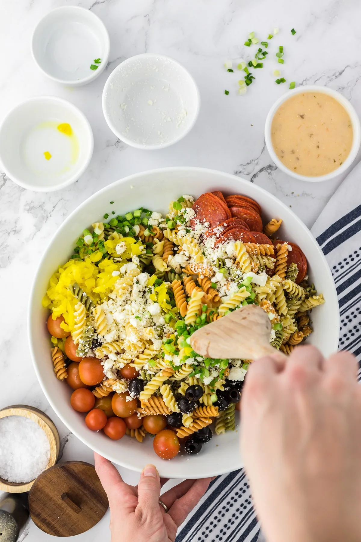 stirring pasta salad mixture