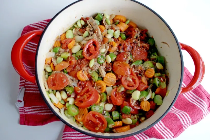 Frozen veggies and tomatoes in dutch oven