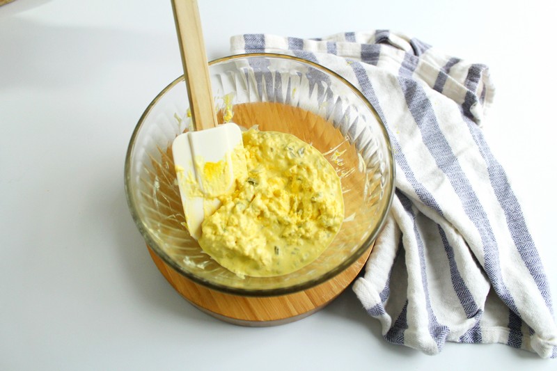 deviled egg filling in bowl with spoon