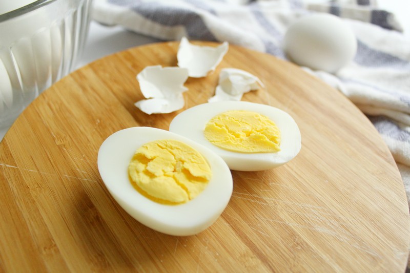 two boiled egg halves on cutting board