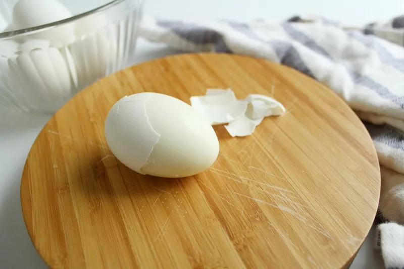 Peeled egg on cutting board
