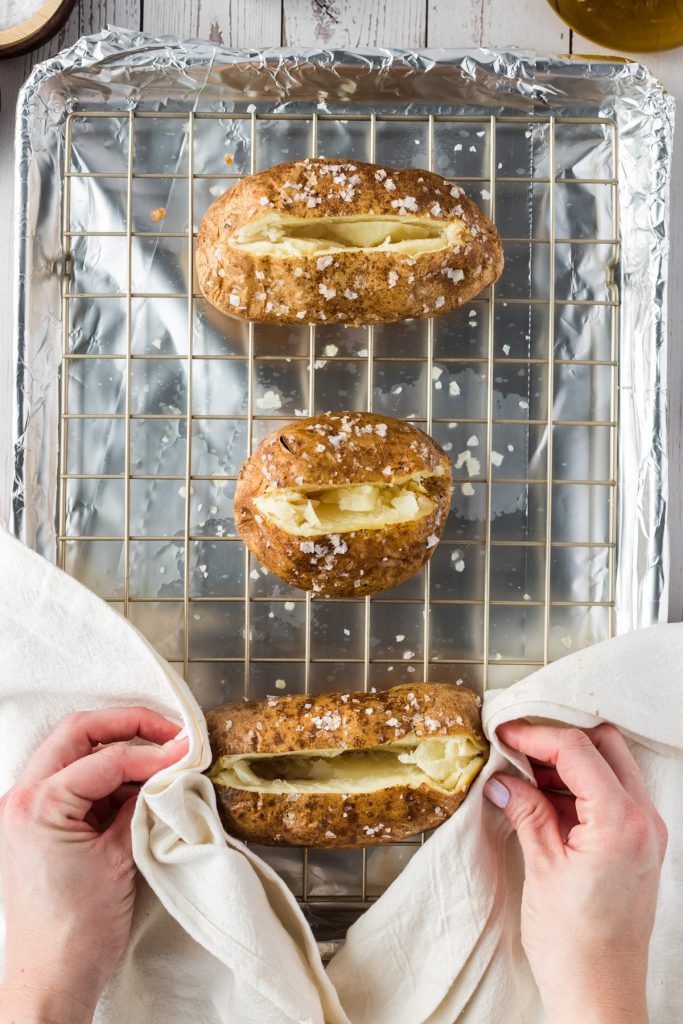 opening up baked potatoes 