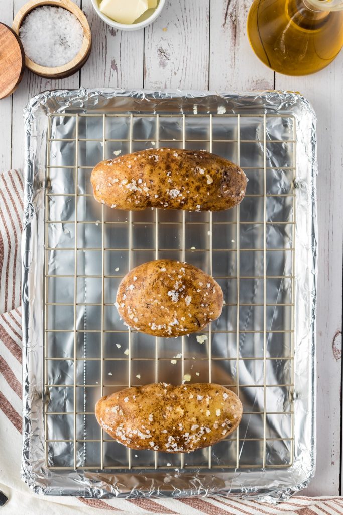 three potatoes on baking sheet