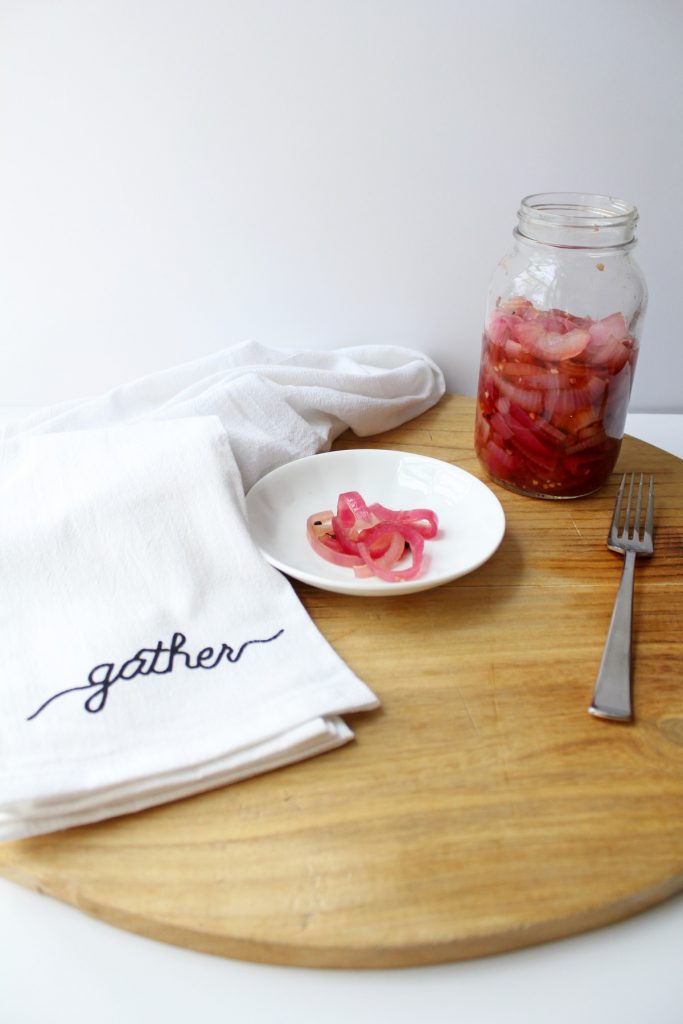 Pickled red onion on a plate overhead