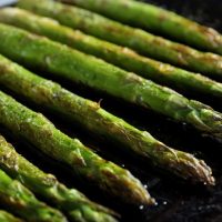 Roasted asparagus on pan, close-up