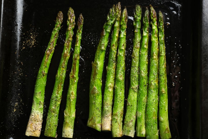 Roasted asparagus on pan, close-up