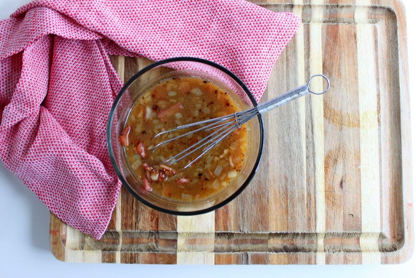 Overhead shot of dressing in a bowl with whisk