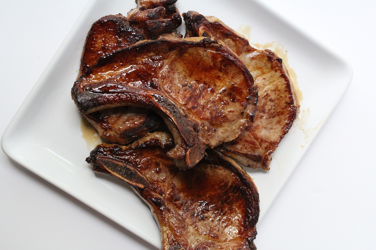 grilled pork chops on white plate