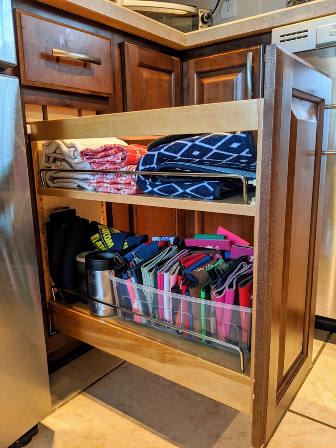 Dishtowels and drink koozies stored in rev a shelf pull out cabinet