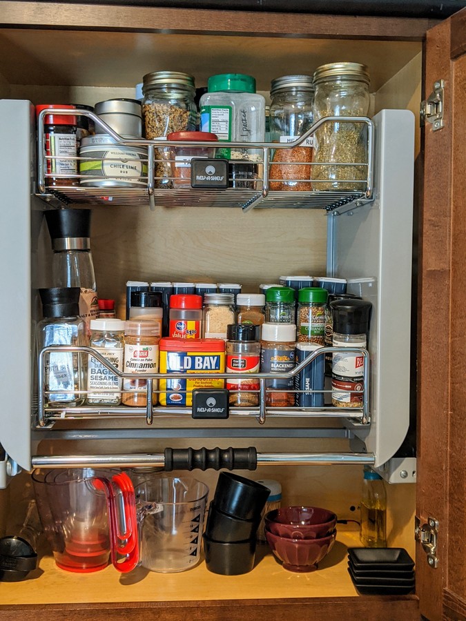 Pull down spice rack in cabinet with spices