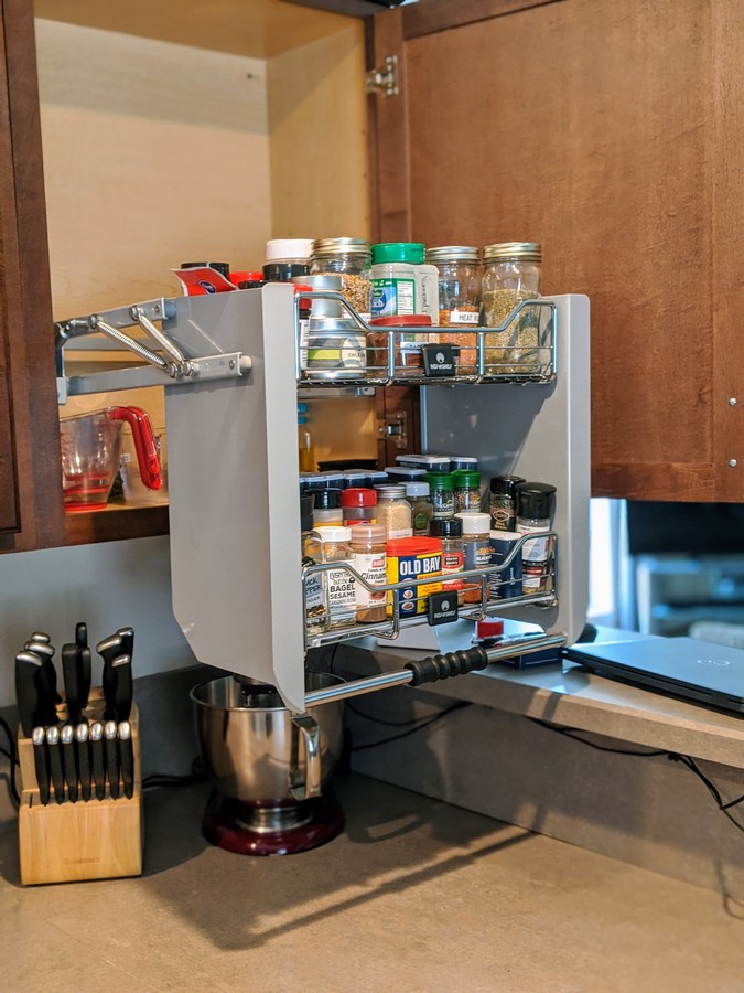 Pull down cabinet with spice storage pulled out of cabinet