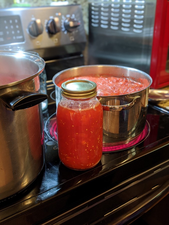 Jar of tomatoes on stove