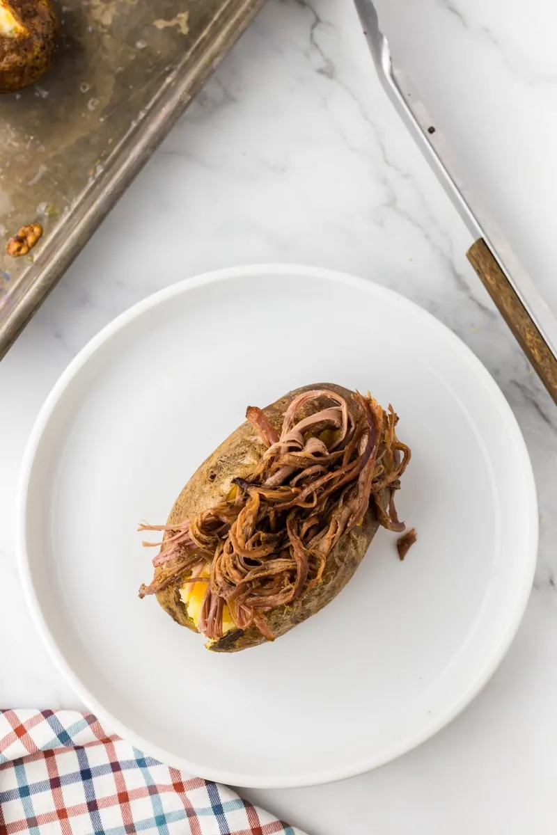 shredded brisket on a potato