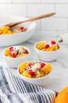 ambrosia fruit salad in small white bowls