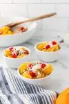 ambrosia fruit salad in small white bowls