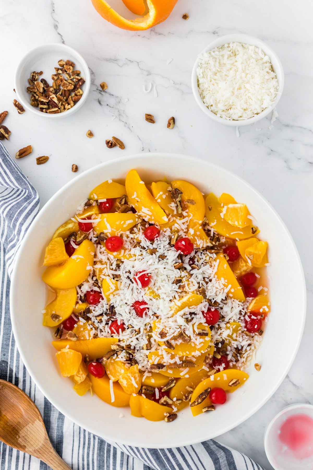 bowl of ambrosia fruit salad with ingredients