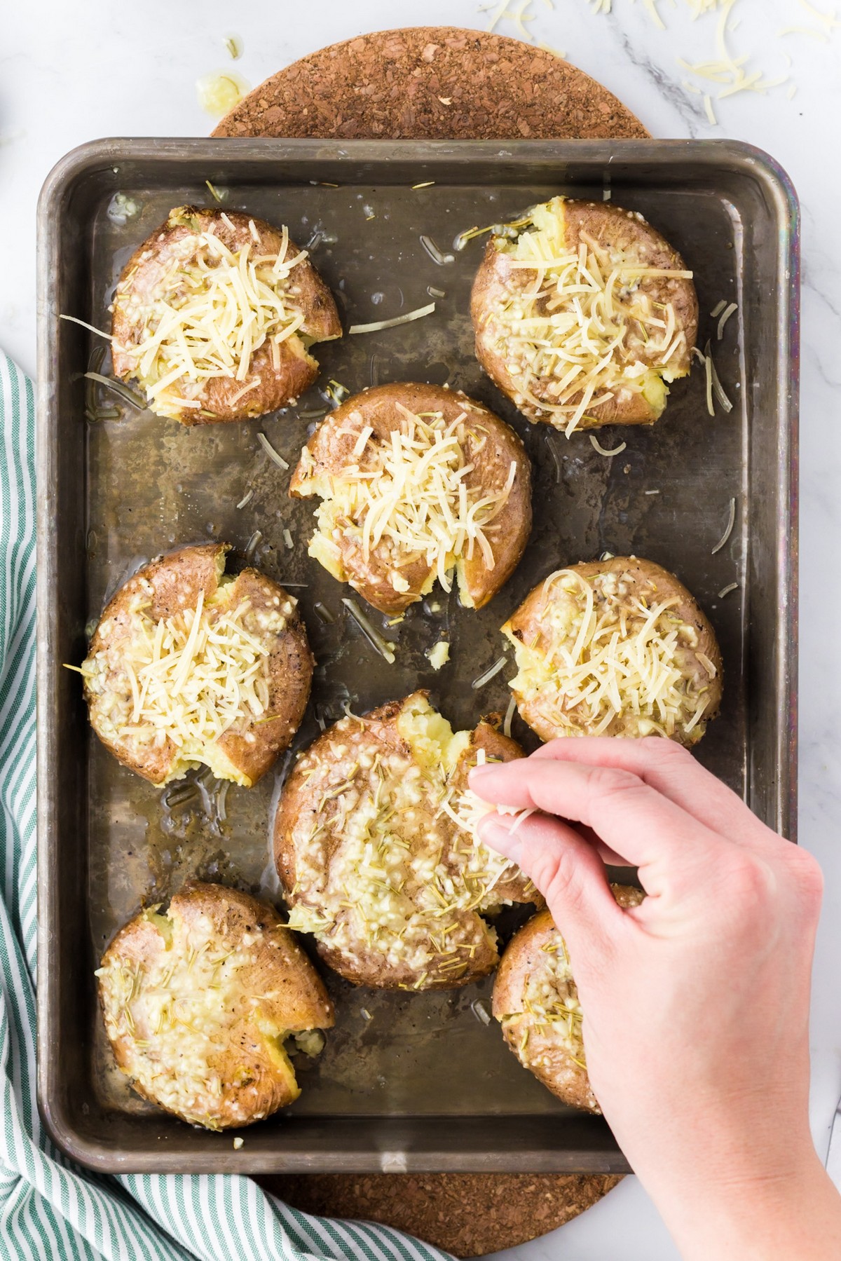 adding cheese to smashed potatoes