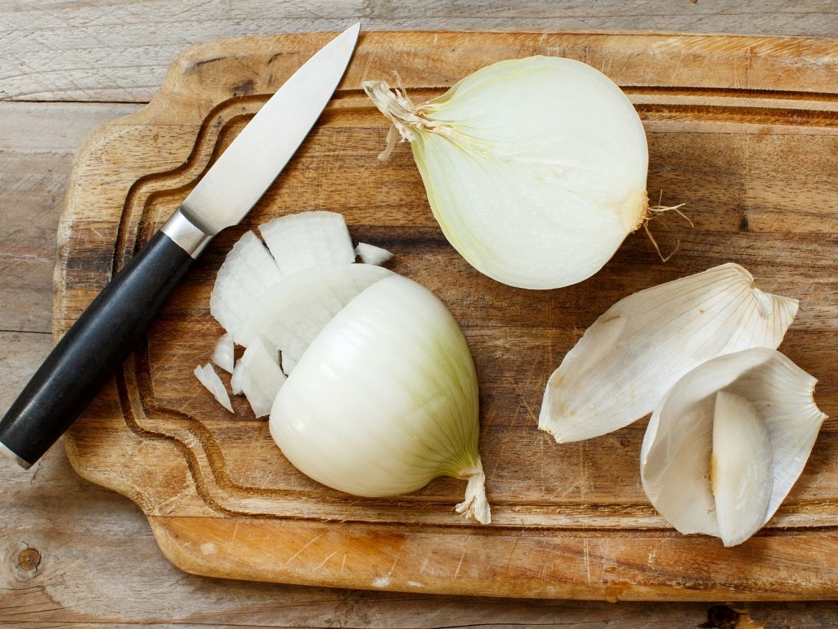 white onions halved on cutting board