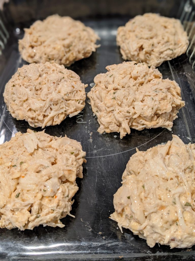 6 crab cakes patties in casserole dish uncooked