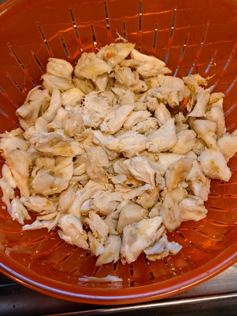 Draining crab meat in collander