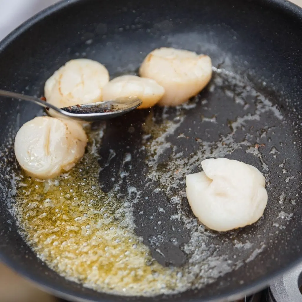 Basting scallops with butter in cast iron pan