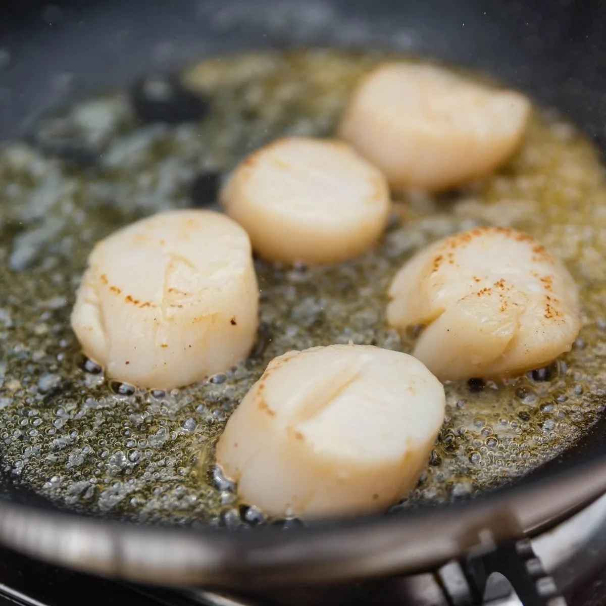 Scallops in pan with butter