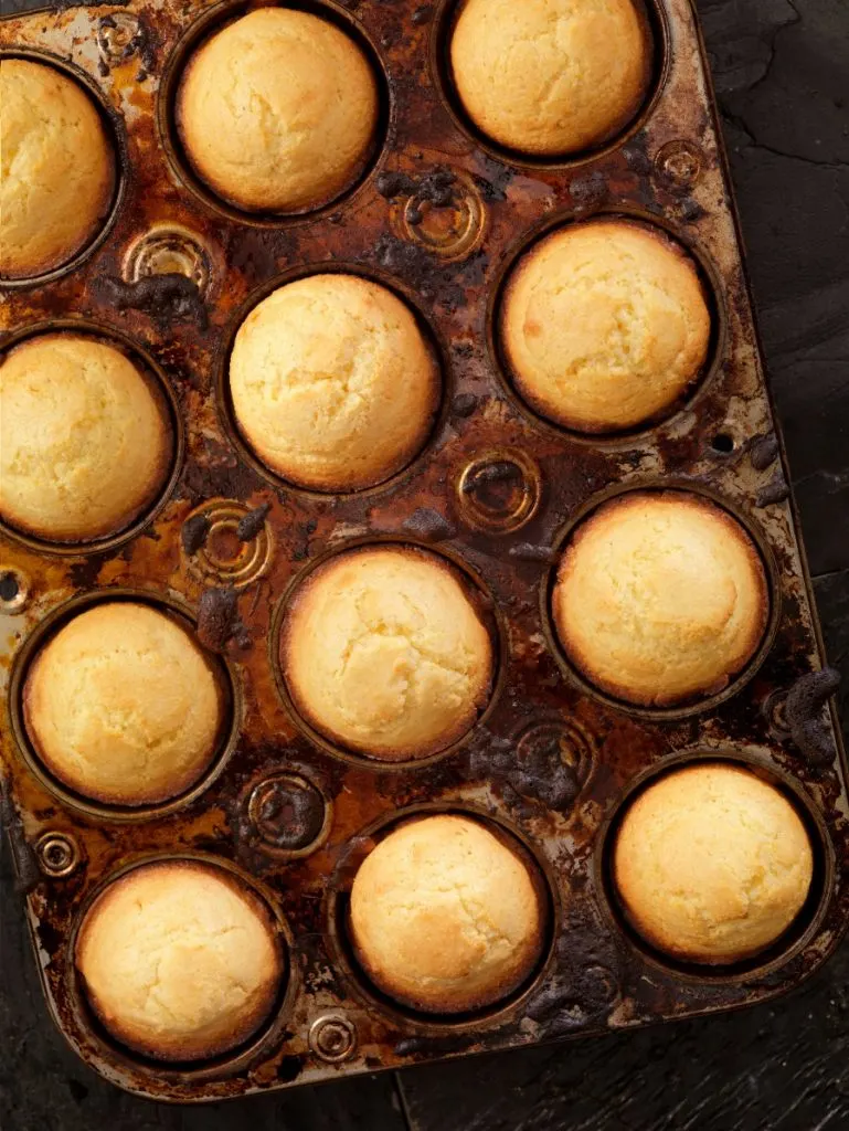 Dark muffin tin of corn muffins