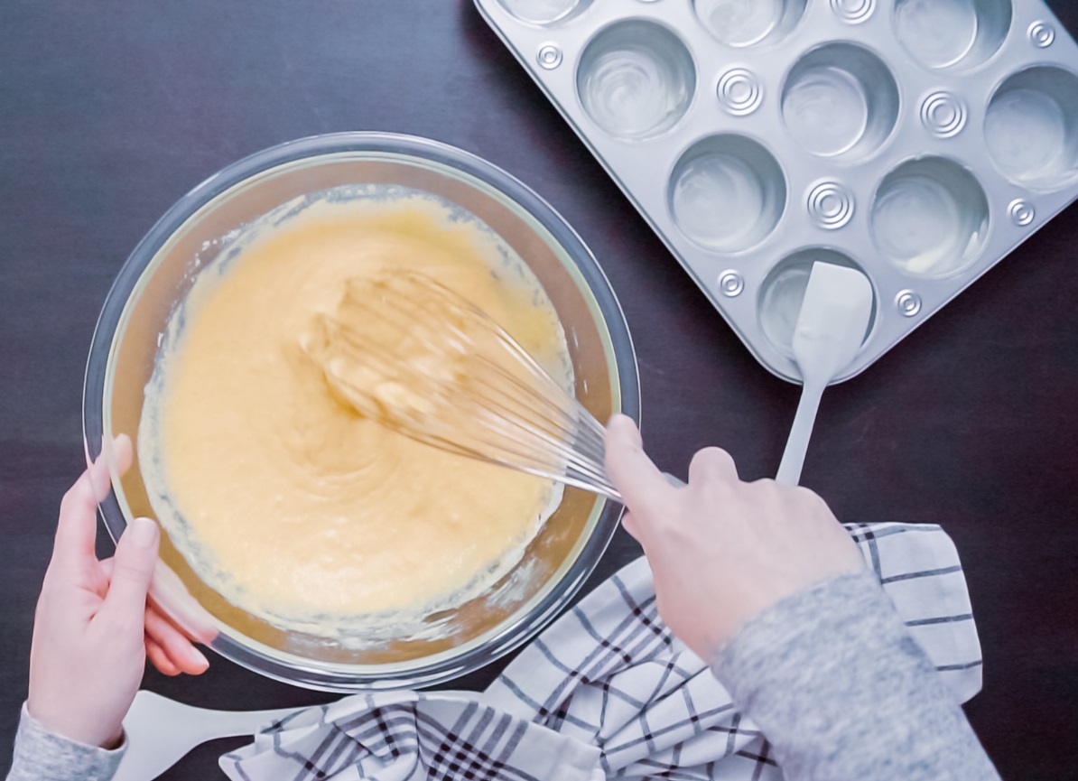 Corn muffin batter in bowl with whisk