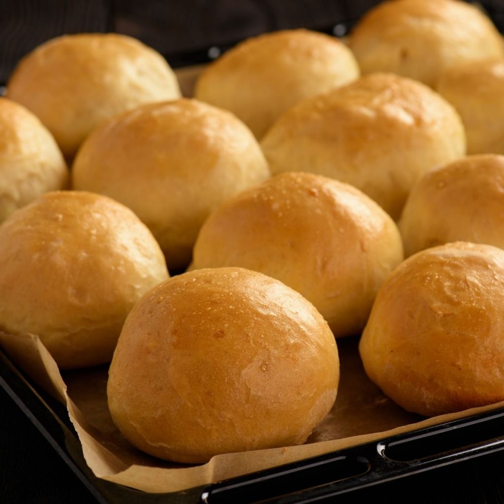 Prepared potato rolls on baking sheet