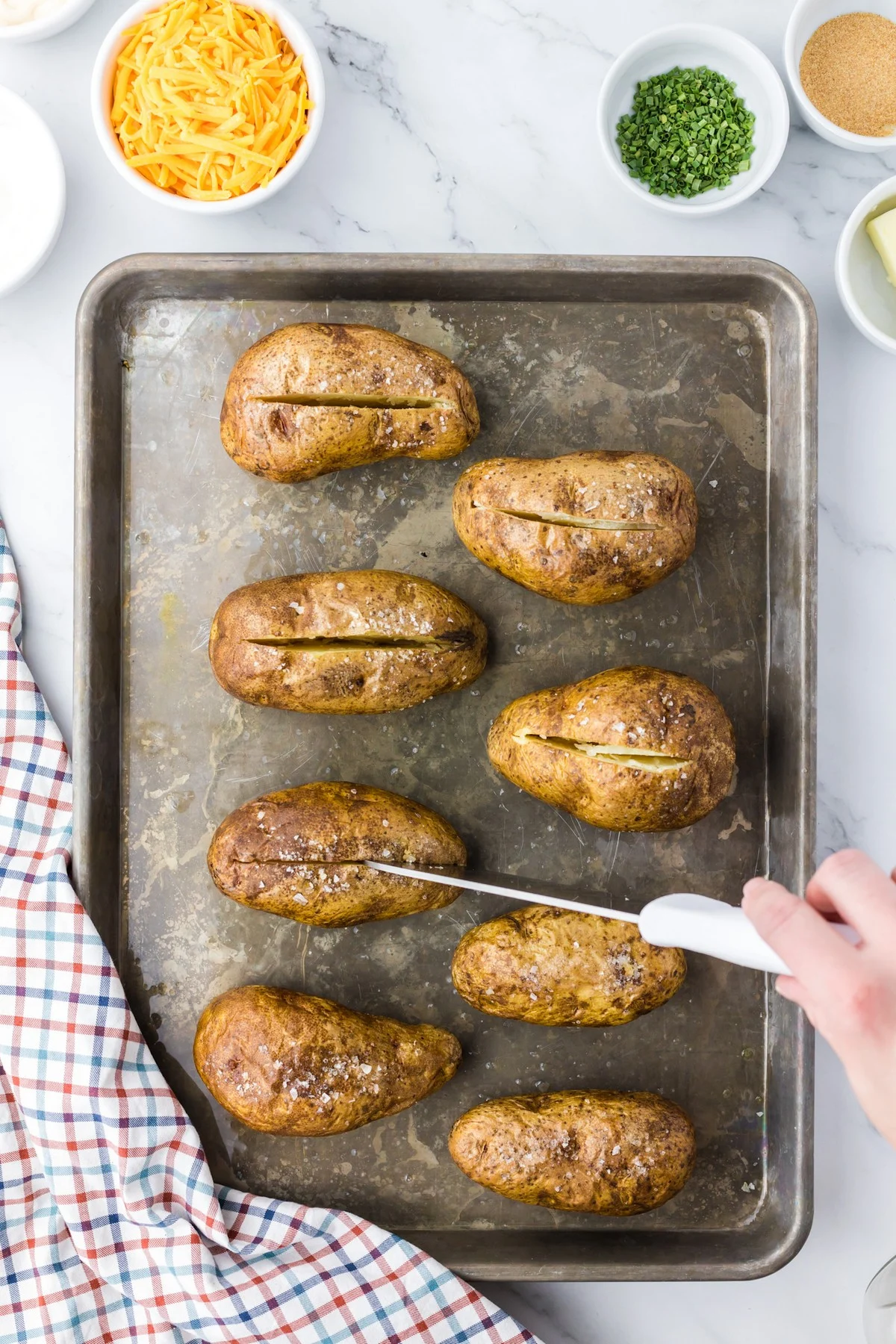 splitting potatoes open with knife