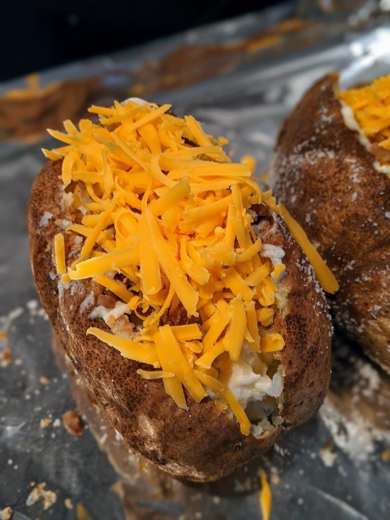 baked potato with shredded cheddar cheese