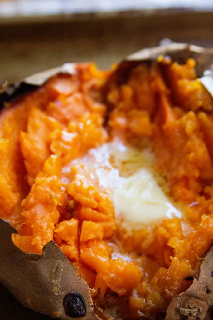 Up close photo of baked sweet potato and butter
