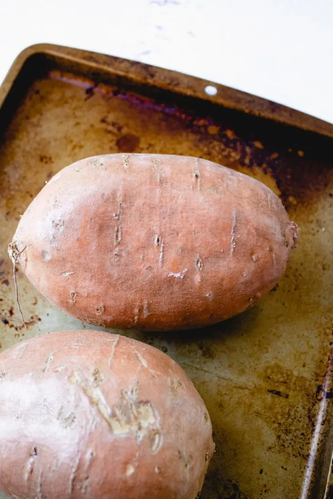 Uncooked sweet potato on baking pan