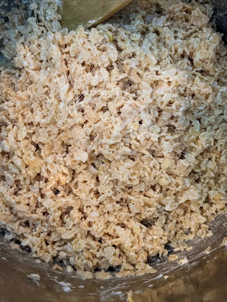 stirring rice krispie treats in pot
