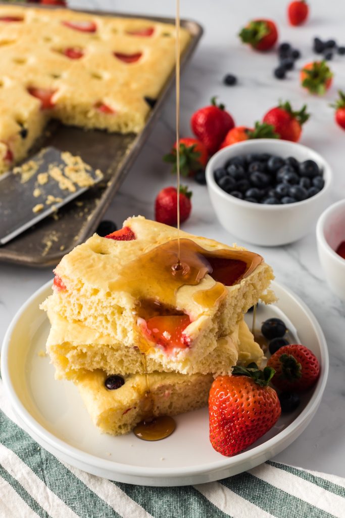 sheet pan pancakes with syrup drizzle