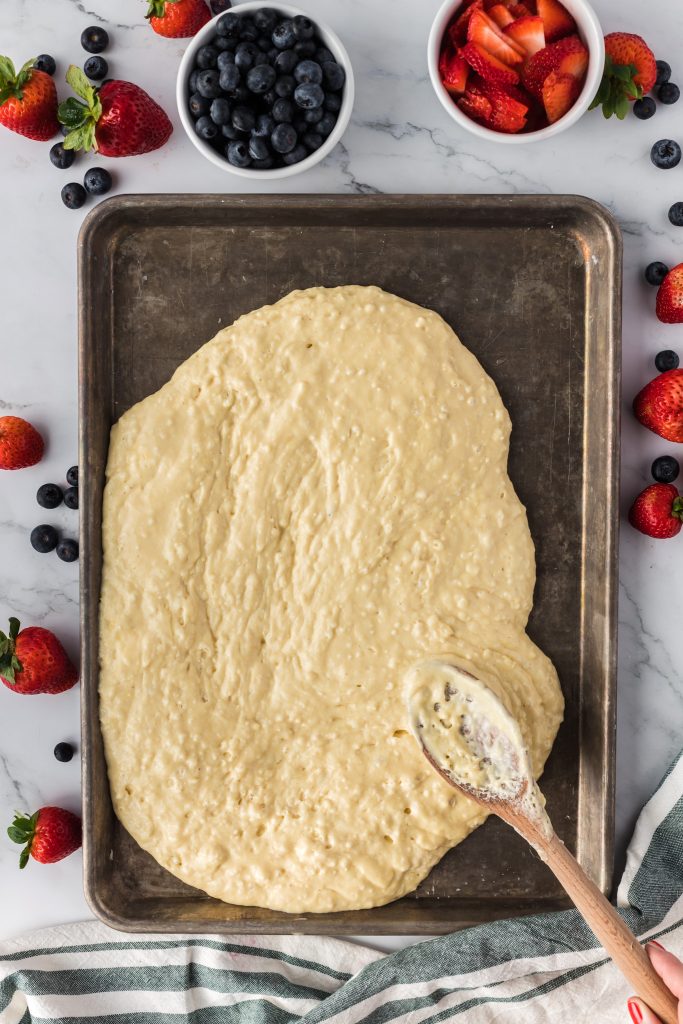 spreading pancake batter on sheetpan