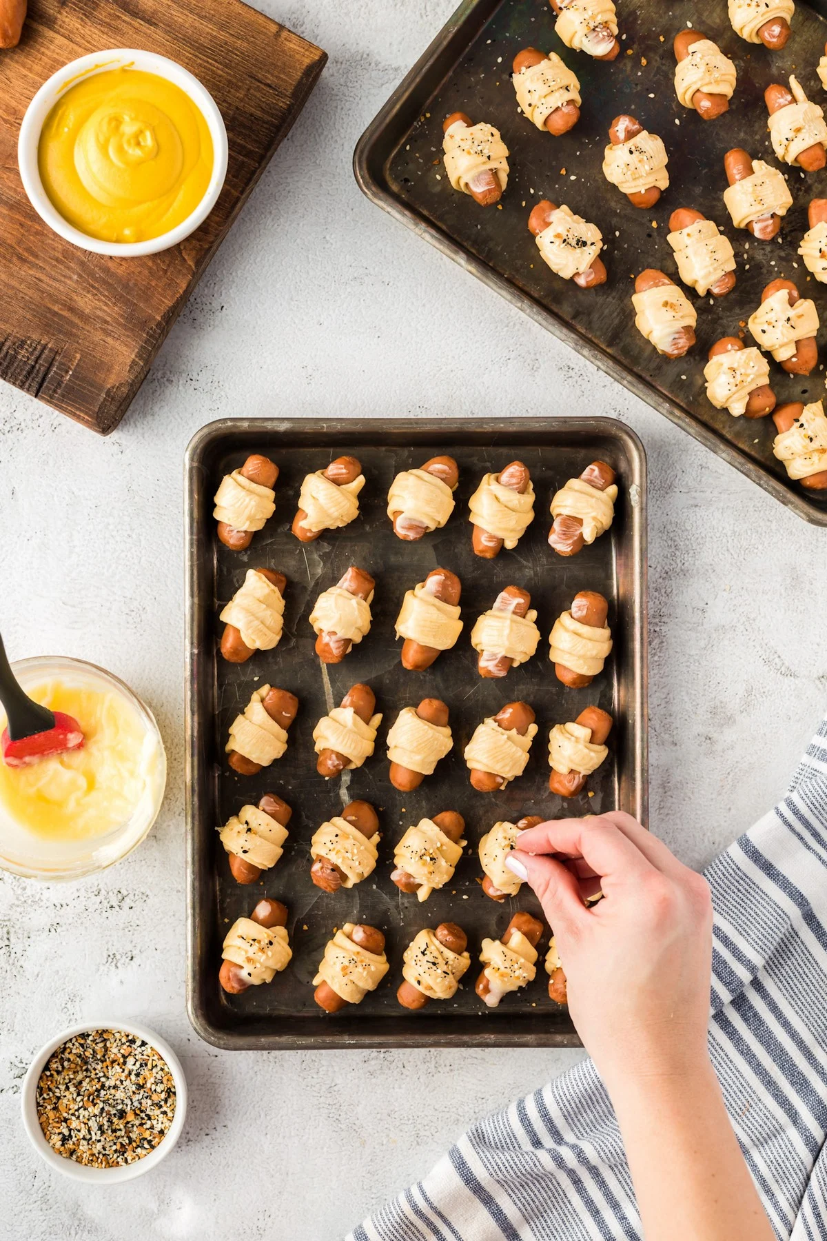 adding everything seasoning to pigs in a blanket