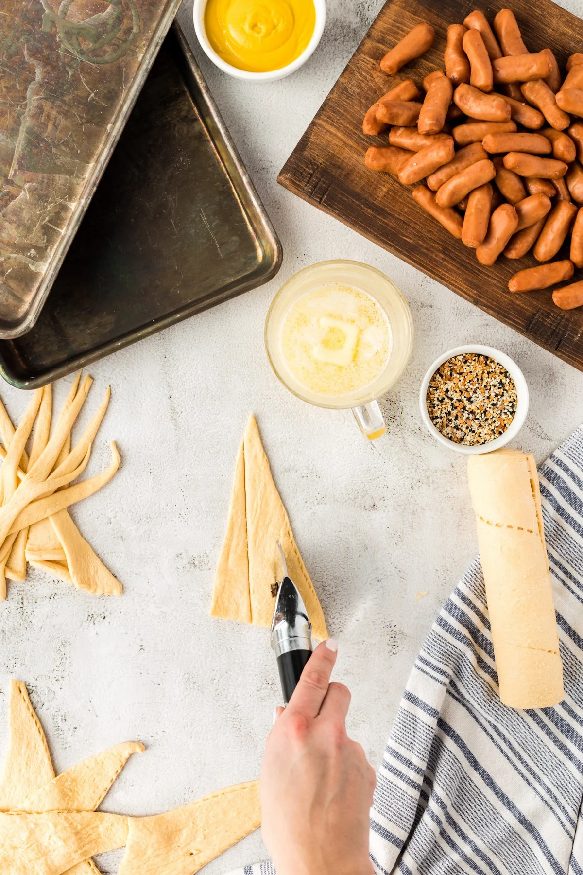 slicing crescent roll dough into triangles