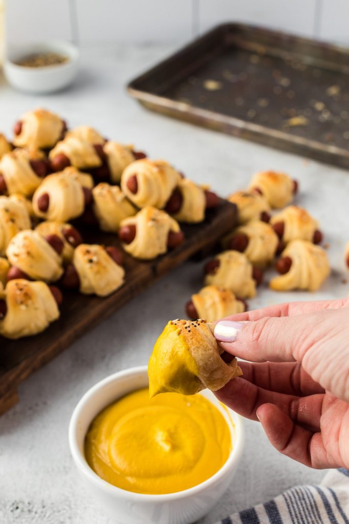 pigs in a blanket dipped in mustard