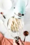 cream cheese frosting on whisk