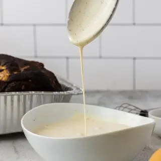 white sauce with wooden spoon and white bowl