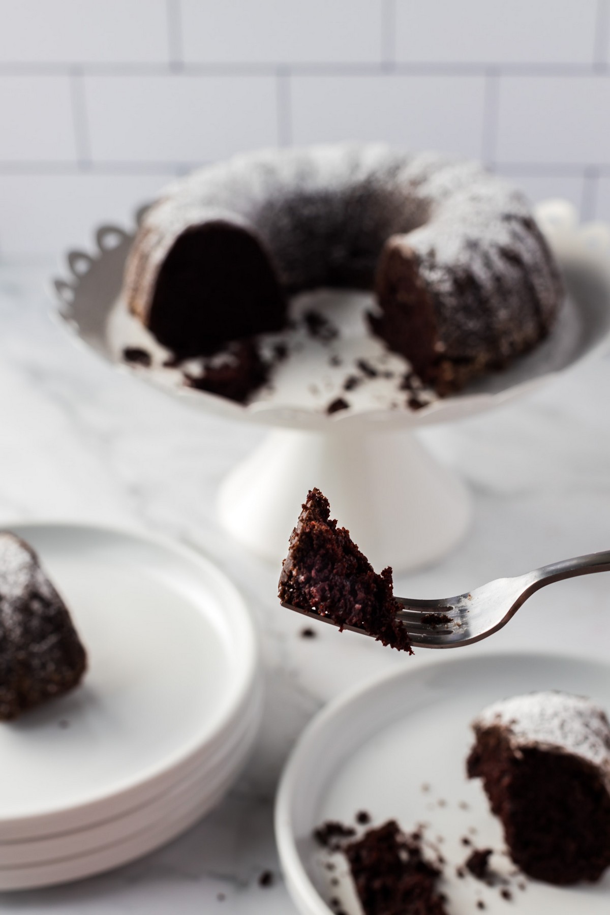 chocolate cake on fork with cake in background