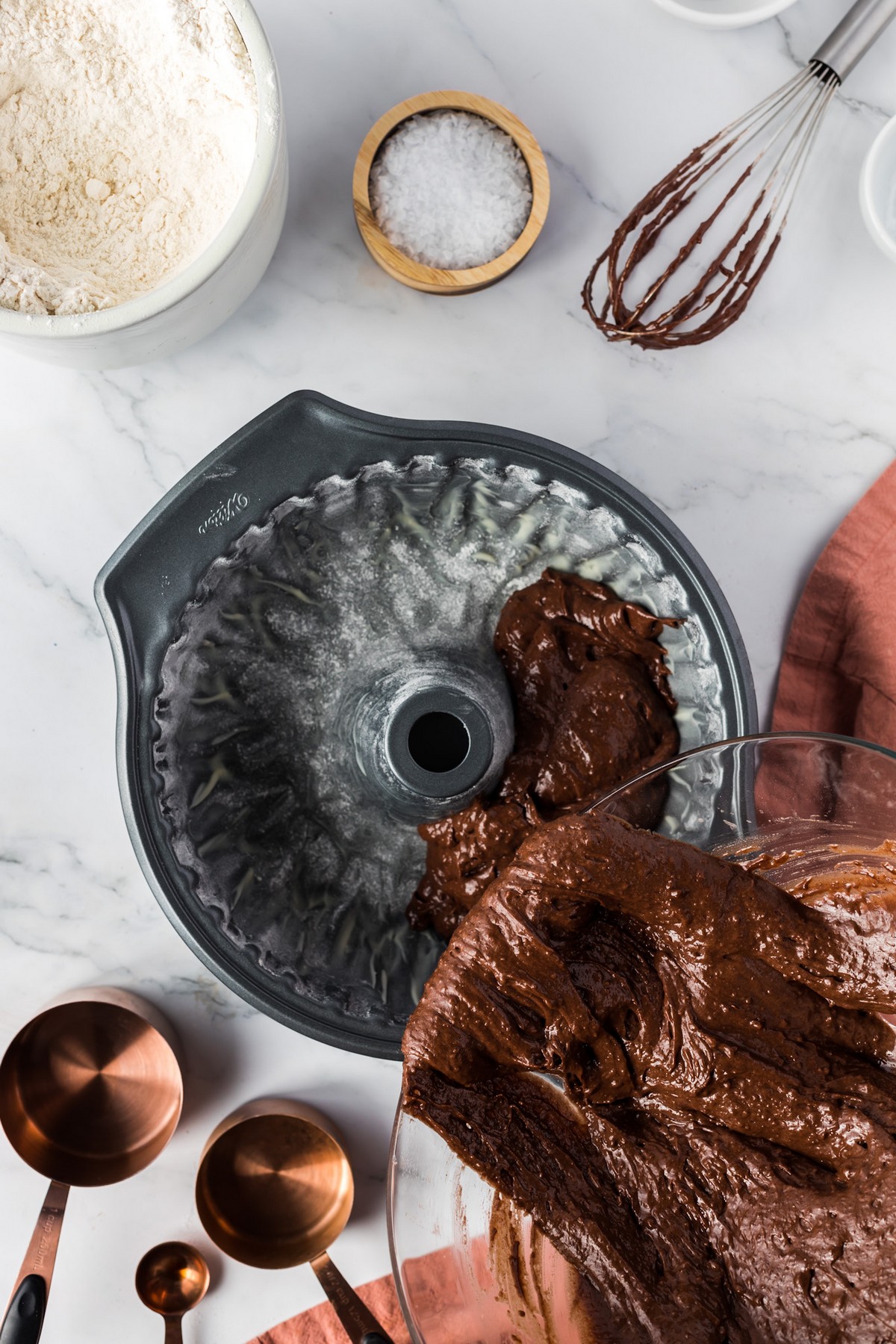 pouring chocolate cake batter into bundt pan