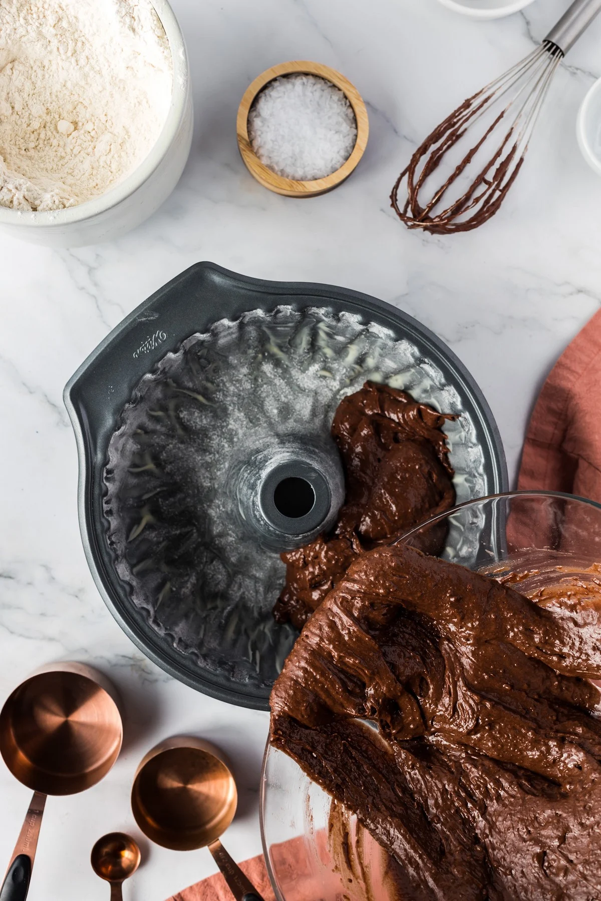 pouring chocolate cake batter into bundt pan