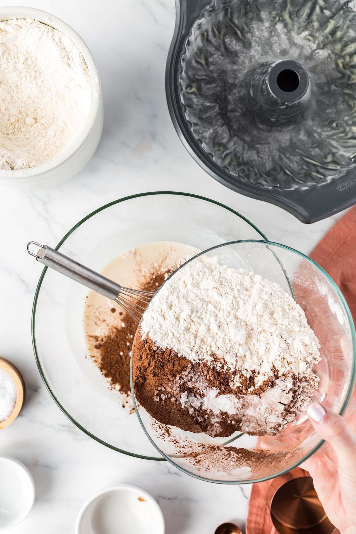 whisking dry ingredients into wet ingredients for cake