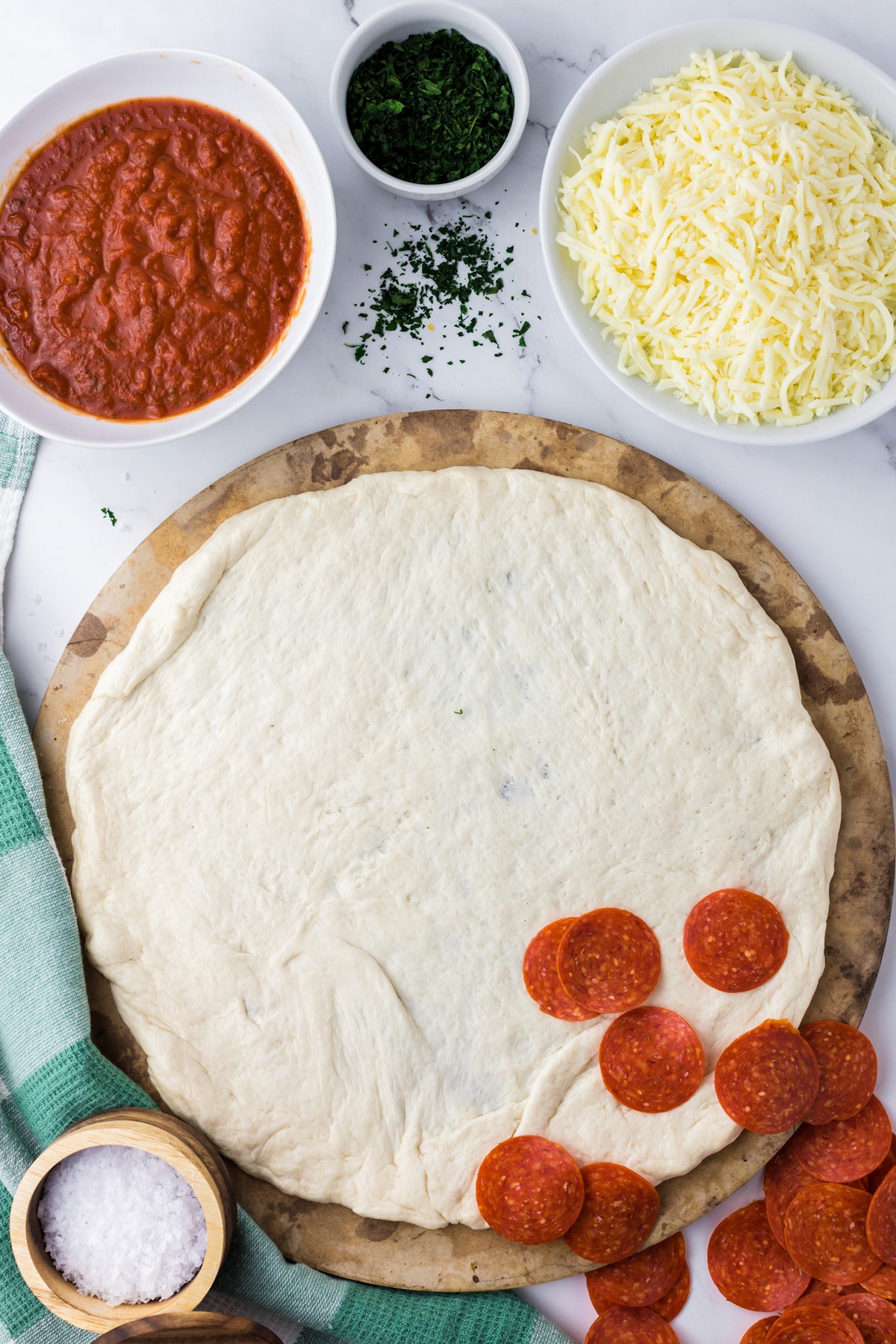 raw pizza dough on stone