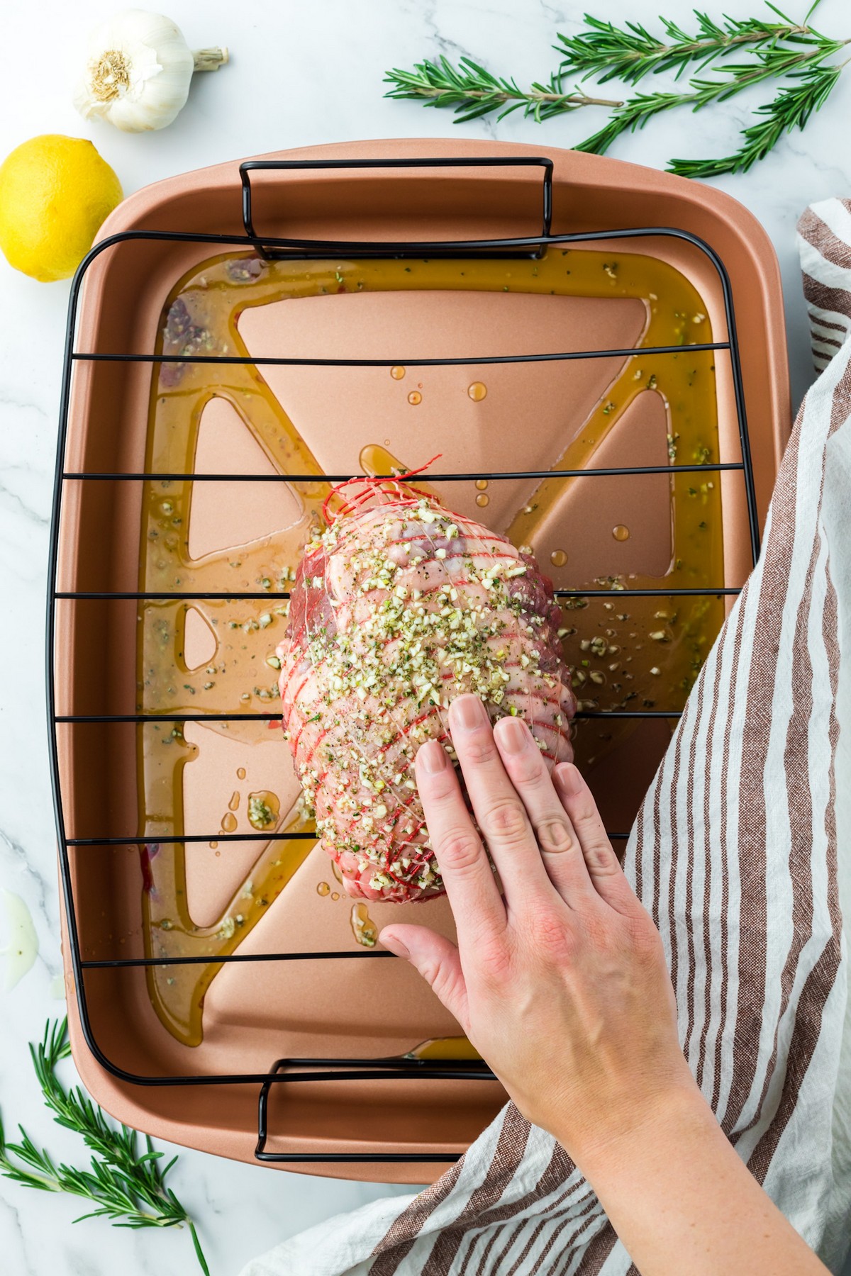 applying marinade to lamb