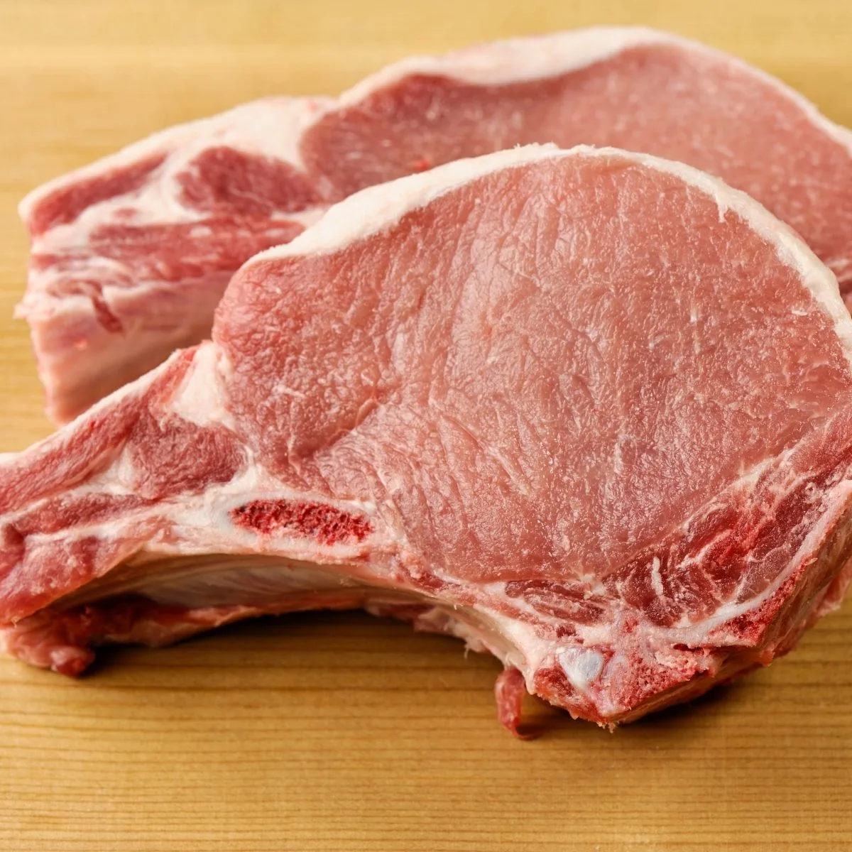 two raw pork chops